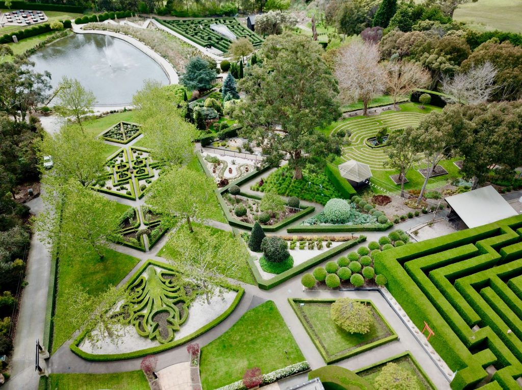 Aerial drone image of formal gardens, mazes and lake at Enchanted Adventure